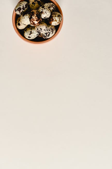 Speckled quail eggs in a ceramic bowl